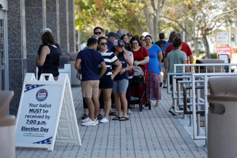 Florida residents wait in line at an early polling precinct to cast their ballots in local, state, and national elections, in Clearwater, Florida, the United States