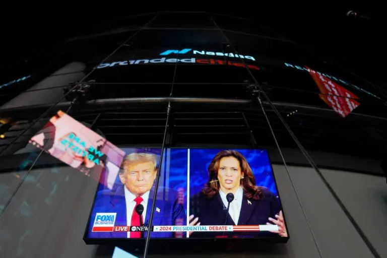 A screen shows the presidential debate between Republican nominee Donald Trump and Democratic nominee Kamala Harris outside the Nasdaq MarketSite